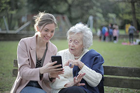 Senior and teen on phone