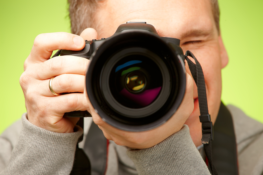 bigstock-Male-photographer-taking-photo-32517002